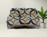 Spectra Cotton Blend Blanket Throw in Blue, draped over a chair