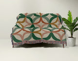 Spectra Cotton Blend Blanket Throw in Green, draped over a chair