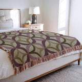 Spectra Cotton Blend Blanket Throw in Purple, on a bed