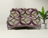 Spectra Cotton Blend Blanket Throw in Purple, draped over a chair