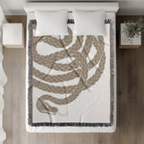 Spiga Snake Cotton Blend Blanket Throw in Beige, on a bed