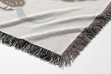 Spiga Snake Cotton Blend Blanket Throw in Beige, draped over a chair