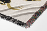 Spiga Snake Cotton Blend Blanket Throw in Black, draped over a chair