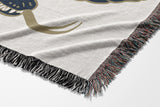 Spiga Snake Cotton Blend Blanket Throw in Blue, draped over a chair