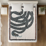Spiga Snake Cotton Blend Blanket Throw in Gray, on a bed