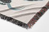 Spiga Snake Cotton Blend Blanket Throw in Gray, draped over a chair
