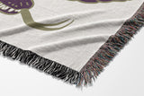 Spiga Snake Cotton Blend Blanket Throw in Purple, draped over a chair