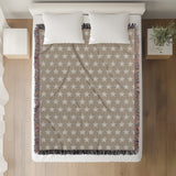 Stella Cotton Blend Blanket Throw in Beige and Off-White, on a bed