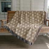 Stella Cotton Blend Blanket Throw in Beige and Off-White, draped over a chair