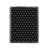 Stella Cotton Blend Blanket Throw in Black and Off-White, on a bed