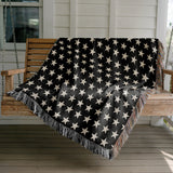 Stella Cotton Blend Blanket Throw in Black and Off-White, draped over a chair