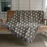 Stella Cotton Blend Blanket Throw in Gray and Off-White, draped over a chair