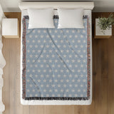Stella Cotton Blend Blanket Throw in Light Blue and Off-White, on a bed