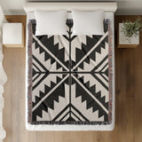 Tala Southwestern Cotton Blend Blanket Throw in Black and Off-White, on a bed