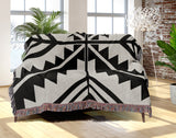 Tala Southwestern Cotton Blend Blanket Throw in Black and Off-White, draped over a chair