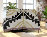 Tala Southwestern Cotton Blend Blanket Throw in Black, Dull Gold and Off-White, draped over a chair