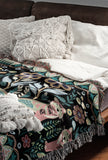 Tia Folksy Tiger Cotton Blend Blanket Throw in Black, Pink, Green and Teal, on a bed