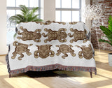 Usha Tibetan Tiger Cotton Blend Blanket Throw in Beige and Off-White, draped over a chair