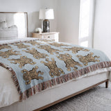Usha Tibetan Tiger Cotton Blend Blanket Throw in Blue and Off-White, on a bed