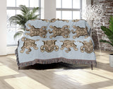 Usha Tibetan Tiger Cotton Blend Blanket Throw in Blue and Off-White, draped over a chair
