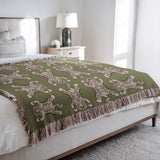 Usha Tibetan Tiger Cotton Blend Blanket Throw in Chartreuse and Off-White, on a bed