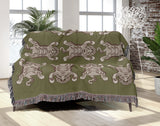 Usha Tibetan Tiger Cotton Blend Blanket Throw in Chartreuse and Off-White, draped over a chair