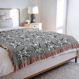 Usha Tibetan Tiger Cotton Blend Blanket Throw in Gray and Off-White, on a bed
