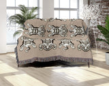 Usha Tibetan Tiger Cotton Blend Blanket Throw in Soft Orange and Off-White, draped over a chair