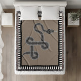 Vanjo Snake Cotton Blend Blanket Throw in Beige, Black and Off-White, on a bed