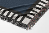 Vanjo Snake Cotton Blend Blanket Throw in Blue, Black and Off-White, draped over a chair