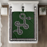 Vanjo Snake Cotton Blend Blanket Throw in Green, Black and Off-White, on a bed