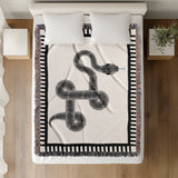 Vanjo Snake Cotton Blend Blanket Throw in Off-White, on a bed