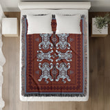 Voha Tibetan Tiger Cotton Blend Blanket Throw in Red, Blue and Burnt Orange, on a bed