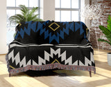 Wapi Southwestern Cotton Blend Blanket Throw in Blue, Black and Off-White, draped over a chair