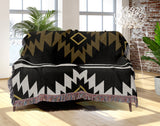 Wapi Southwestern Cotton Blend Blanket Throw in Black, Dull Gold and Off-White, draped over a chair