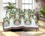 Xavier Zebra Cotton Blend Blanket Throw in Black, Teal, Chartreuse and Off-White, draped over a chair