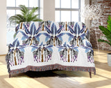 Xavier Zebra Cotton Blend Blanket Throw in Black, Blue and Off-White, draped over a chair