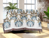 Xavier Zebra Cotton Blend Blanket Throw in Beige, Brown, Dark Teal and Off-White, draped over a chair
