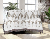 Ziggy Zebra Cotton Blend Blanket Throw in Beige and Off-White, on a bed