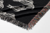 Ziggy Zebra Cotton Blend Blanket Throw in Black and Off-White, draped over a chair
