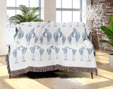 Ziggy Zebra Cotton Blend Blanket Throw in Blue and Off-White, on a bed