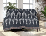 Ziggy Zebra Cotton Blend Blanket Throw in Blue Gray and Off-White, on a bed