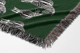 Ziggy Zebra Cotton Blend Blanket Throw in Green and Off-White, draped over a chair