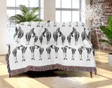 Ziggy Zebra Cotton Blend Blanket Throw in Off-White, on a bed