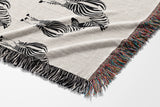 Ziggy Zebra Cotton Blend Blanket Throw in Off-White, draped over a chair