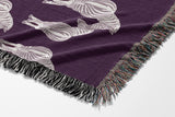 Ziggy Zebra Cotton Blend Blanket Throw in Purple and Off-White, draped over a chair