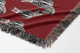Ziggy Zebra Cotton Blend Blanket Throw in Red and Off-White, draped over a chair