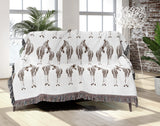 Ziggy Zebra Cotton Blend Blanket Throw in Rust Brown and Off-White, on a bed