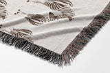 Ziggy Zebra Cotton Blend Blanket Throw in Rust Brown and Off-White, draped over a chair