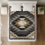 Zio Southwestern Cotton Blend Blanket Throw in Black, Gray, Dull Gold and Off-White, on a bed